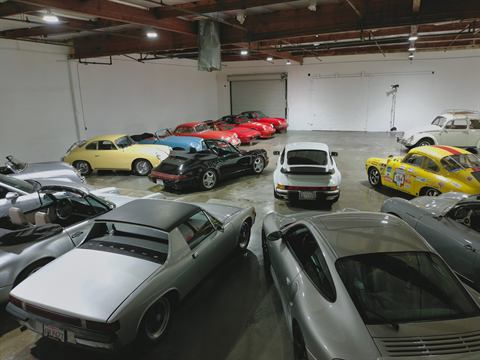 Private collection of classic Porsche 911s and 914s parked in a warehouse studio
