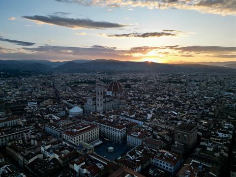 Sunset aerial over the rooftops of Florence with the Duomo on the skyline