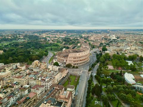 Dawn aerial over Rome with the Colosseum rising from the city