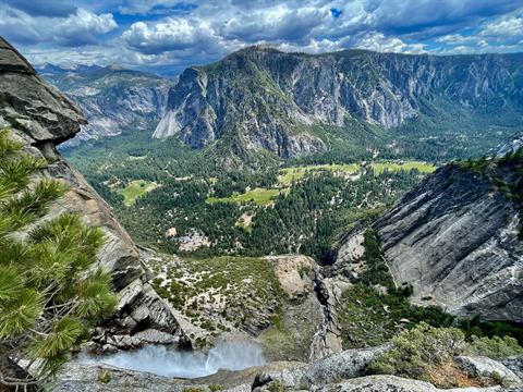 Looking down into Yosemite Valley from a granite ledge